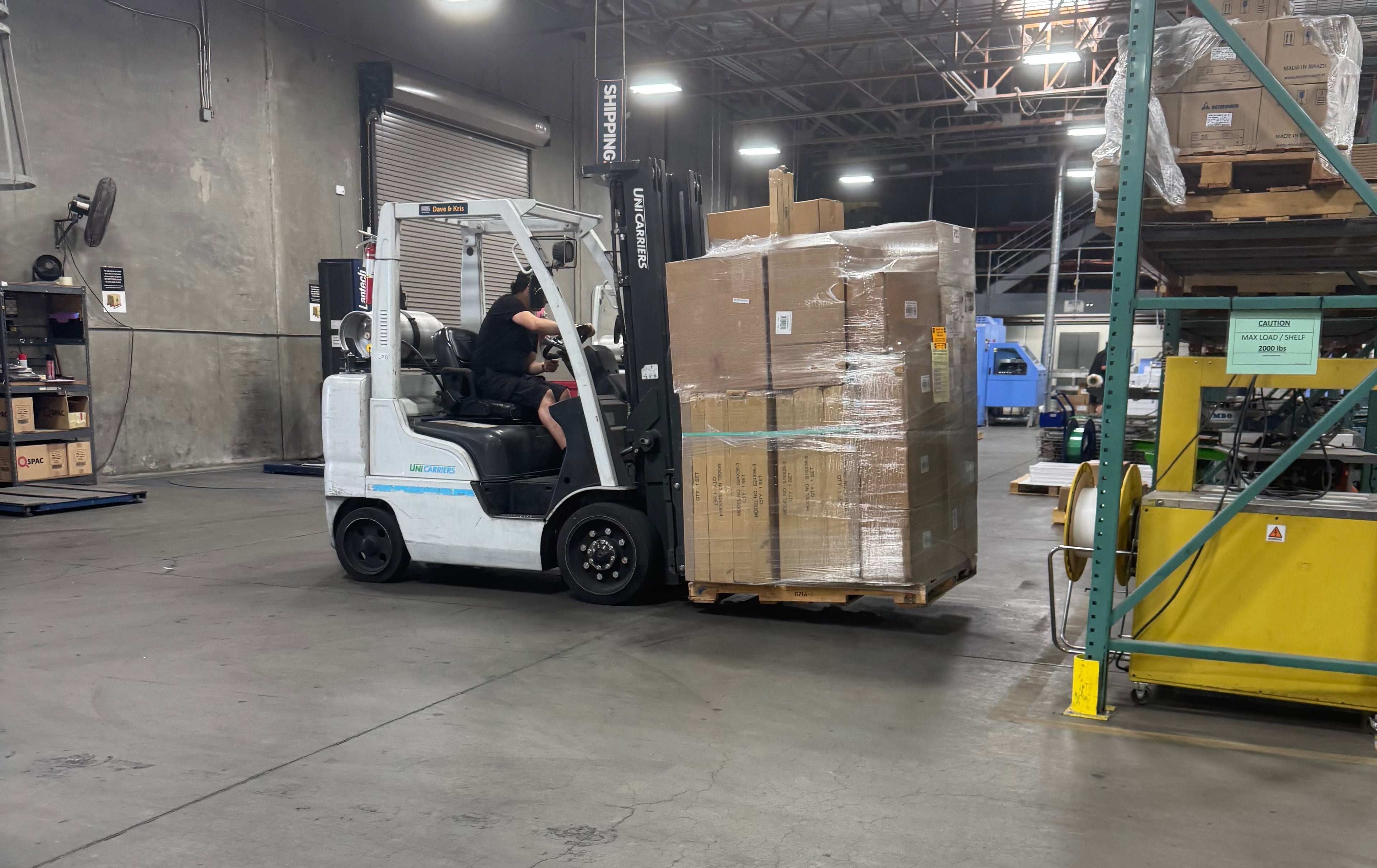 Forklift moving boxes in a warehouse